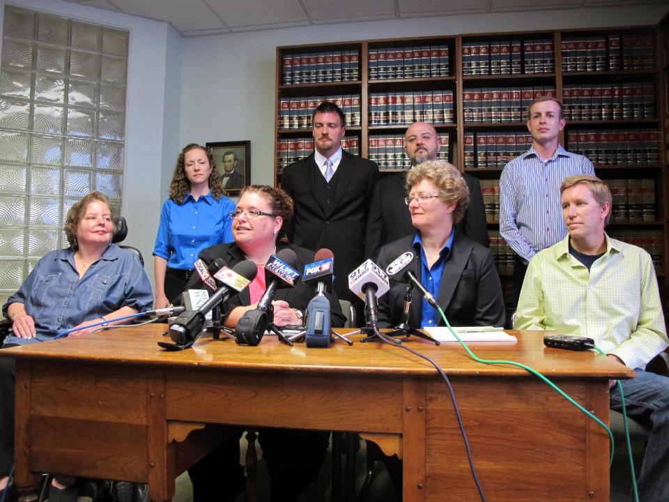 Civil rights attorneys Jennifer Branch, center left, and Lisa Meeks, center right, talk about the lawsuit they filed in federal court in Cincinnati seeking to strike down Ohio's gay marriage ban, Wednesday, April 30, 2014. They are surrounded by some of the gay couples who are named as plaintiffs in the lawsuit, including, from left, Michelle Gibson, Mary Koehler, Karl Rece Jr., Gary Goodman, Ethan Fletcher and Ronny Beck. (AP Photo/Amanda Lee Myers)