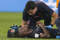 Ecuador's Enner Valencia is attended by medical personnel during the World Cup group A soccer match between Netherlands and Ecuador, at the Khalifa International Stadium in Doha, Qatar, Friday, Nov. 25, 2022. (AP Photo/Darko Vojinovic)