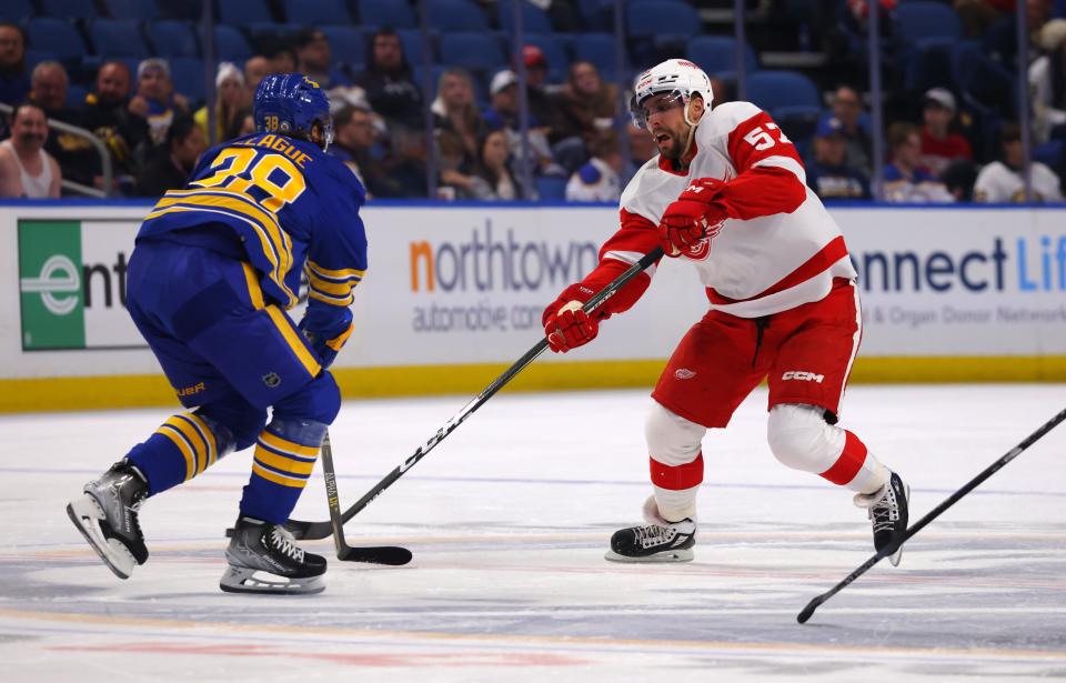 Detroit Red Wings left wing David Perron (57) makes a pass as Buffalo Sabres defenseman Kale Clague (38) defends during the first period at KeyBank Center at KeyBank Center in Buffalo, N.Y. on Monday, Oct. 31, 2022.