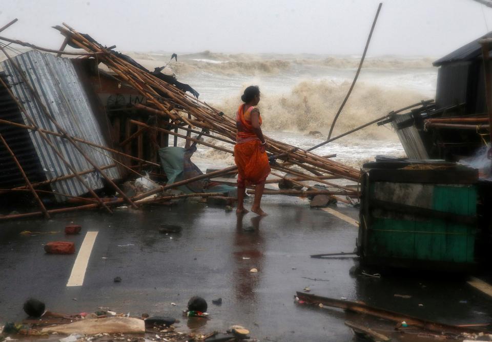 <p>A woman stands next to her stall damaged by heavy winds at a shore ahead of Cyclone Yaas in Bichitrapur</p> (REUTERS)