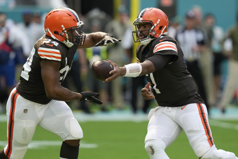Cleveland Browns quarterback Jacoby Brissett (7) hands the back to running back Nick Chubb (24) during the first half of an NFL football game against the Miami Dolphins, Sunday, Nov. 13, 2022, in Miami Gardens, Fla. (AP Photo/Lynne Sladky)