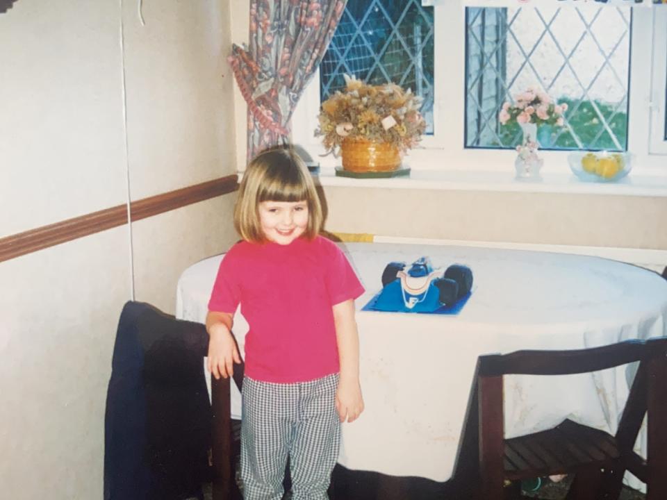 Chloe-Louise Bond, who was formally diagnosed with ADHD as a child, poses in front of a table and Happy Birthday banner around the age of five. Her mother began to notice her symptoms at the