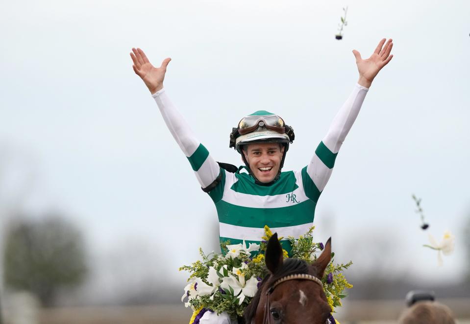 Jockey Flavien Prat celebrates by throwing flowers in the air after winning the Breeders' Cup Classic aboard Flightline at Keeneland Race Course. Nov. 5, 2022