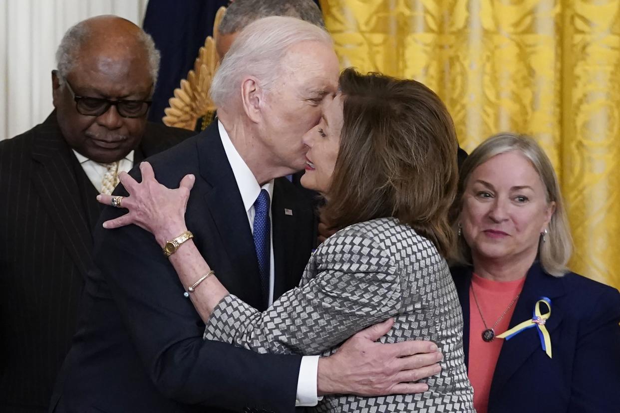 President Joe Biden kisses House Speaker Nancy Pelosi of Calif., during an Affordable Care Act event in the East Room of the White House in Washington, Tuesday, April 5, 2022. 