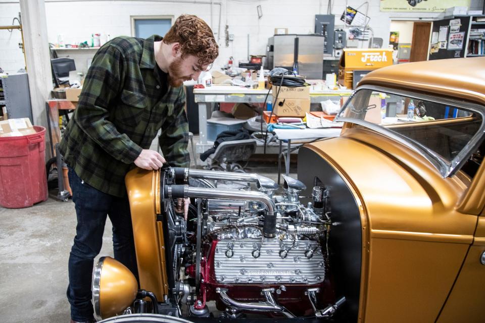 Logan Kucharek checks on his 1932 Ford with flathead V8 engine at the Brothers Custom Automotive in Troy on March 1, 2022.