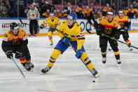 FILE - Sweden's Leo Carlsson, center, controls the puck during the group A match between Sweden and Germany at the ice hockey world championship in Tampere, Finland, Friday, May 12, 2023. The Swedish center has drawn comparisons to countryman Nicklas Backstrom and other elite NHL players.(AP Photo/Pavel Golovkin, File)