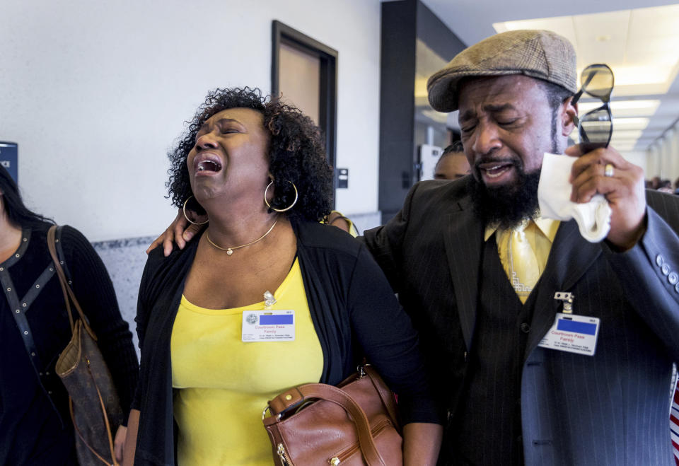 Kattie Jones and her husband, Clinton Jones, Sr., father of Corey Jones, walk down the hall from the courtroom after Nouman Raja was found guilty Thursday, March 7, 2019 in West Palm Beach. Raja, 41, faces a mandatory minimum of 25 years at sentencing April 26, and could spend his life in prison for the death of Corey Jones. (Greg Lovett/Palm Beach Post via AP, Pool)
