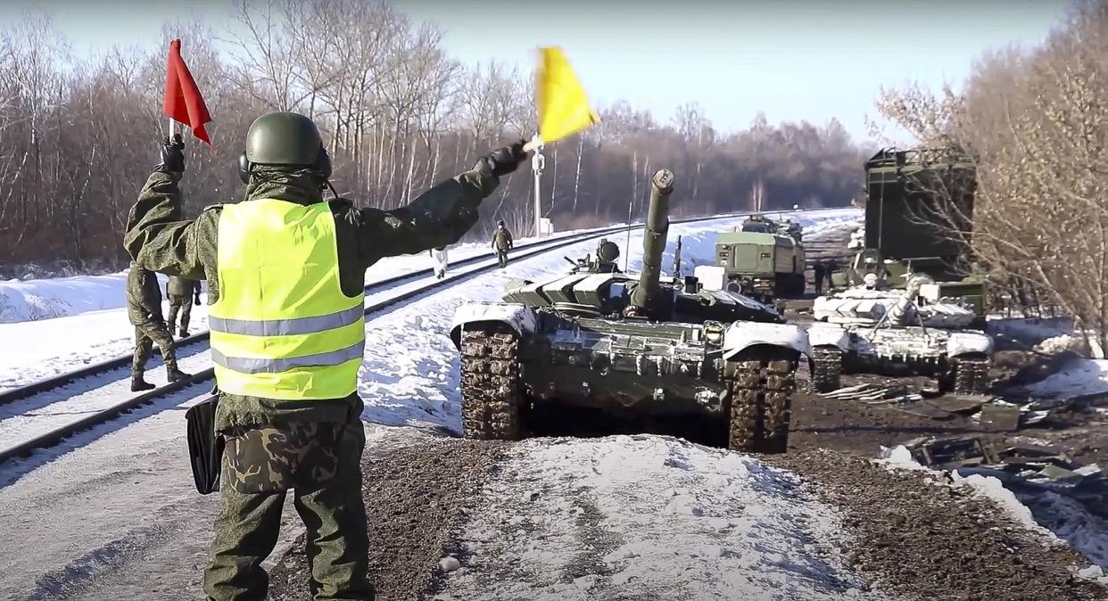 In this photo taken from video provided by the Russian Defense Ministry Press Service on Wednesday, Feb. 16, 2022, Russian army tanks are loaded onto railway platforms to move back to their permanent base after drills in Russia. Russia says it is returning more troops and weapons to bases, but NATO says it sees no sign of a drawdown as fears that Moscow could invade Ukraine soon persist. Russia has massed about 150,000 troops east, north and south of Ukraine.