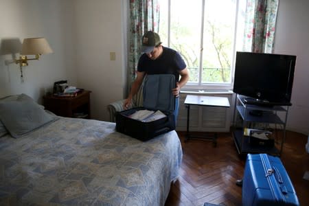 Guillermo Galia prepares his suitcase, in Buenos Aires