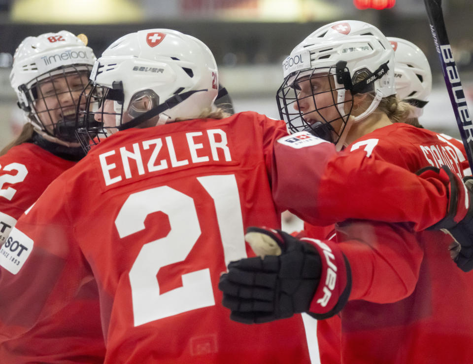 Switzerland forward Lara Stalder, right, celebrates after her goal against Japan with teammates Rahel Enzler (21) and Alessia Baechler (82) during the second period of a women’s world hockey championships quarterfinal, Thursday, April 13, 2023, in Brampton, Ontario. (Frank Gunn/The Canadian Press via AP)