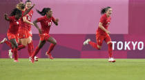 Canada's Jessie Fleming, right, celebrates scoring the opening goal from the penalty spot during a women's semifinal soccer match against United States at the 2020 Summer Olympics, Monday, Aug. 2, 2021, in Kashima, Japan. (AP Photo/Fernando Vergara)