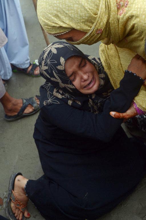 Pakistani women mourn after their drowned brother's body was recovered at Clifton beach in Karachi on August 1, 2014