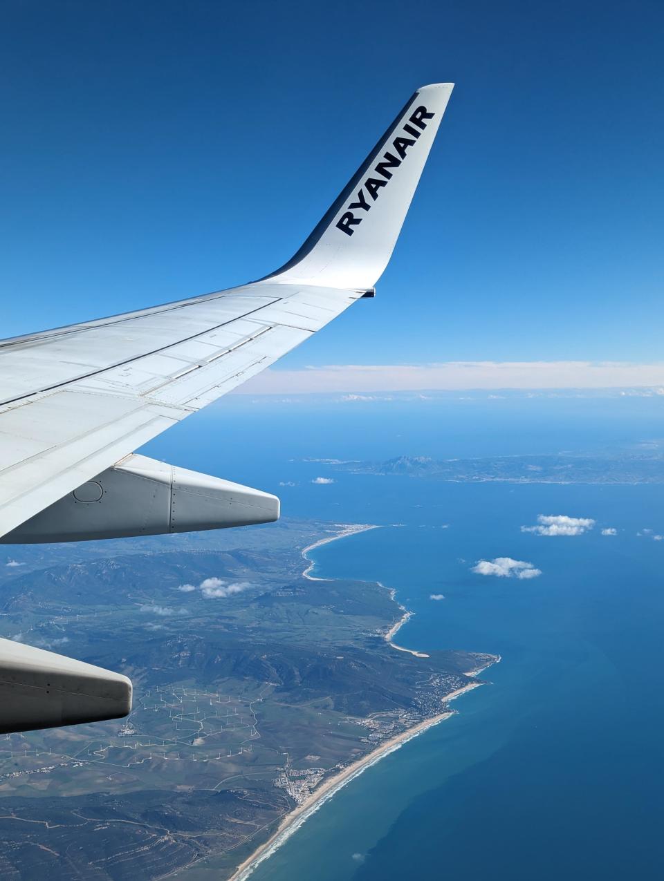 The view from a plane, with two sections of land and lots of ocean