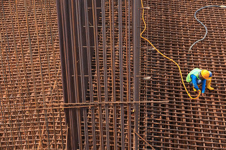 A worker cleans a steel construction on the new Depok-Serpong highway road outskirt of Jakarta, Indonesia, April 18, 2018. REUTERS/Beawiharta