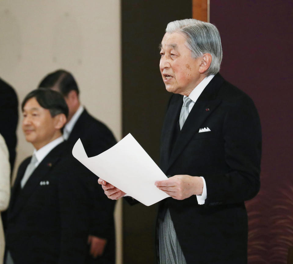Japan's Emperor Akihito speaks during the ceremony of his abdication in front of other members of the royal families and top government officials at the Imperial Palace in Tokyo, Tuesday, April 30, 2019. The 85-year-old Akihito ends his three-decade reign on Tuesday as his son Crown Prince Naruhito, left, will ascend the Chrysanthemum throne on Wednesday. (Japan Pool via AP)