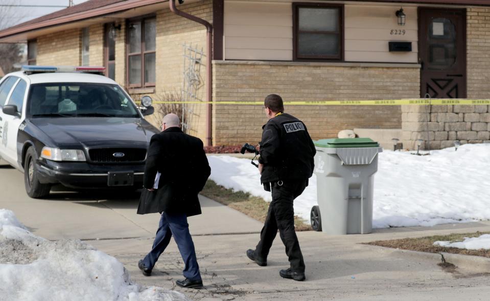 Investigators walk to a home believed to be that of the Molson Coors shooter in the 8200 block of West Potomac Avenue in Milwaukee on Thursday, Feb. 27, 2020.