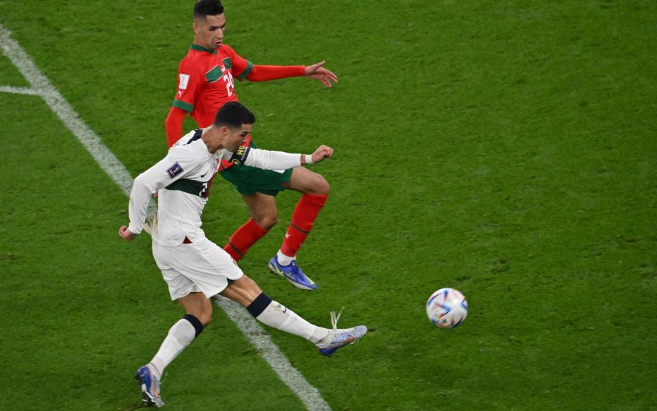 Portugal's forward #07 Cristiano Ronaldo attempts a shot on goal which is denied by Morocco's goalkeeper #01 Yassine Bounou during the Qatar 2022 World Cup quarter-finals football match between Morocco and Portugal at Al-Thumama Stadium of Doha - AFP