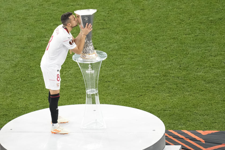 Sevilla's Joan Jordan kisses the trophy after the Europa League final soccer match between Sevilla and Roma, at the Puskas Arena in Budapest, Hungary, Wednesday, May 31, 2023. (AP Photo/Darko Vojinovic)