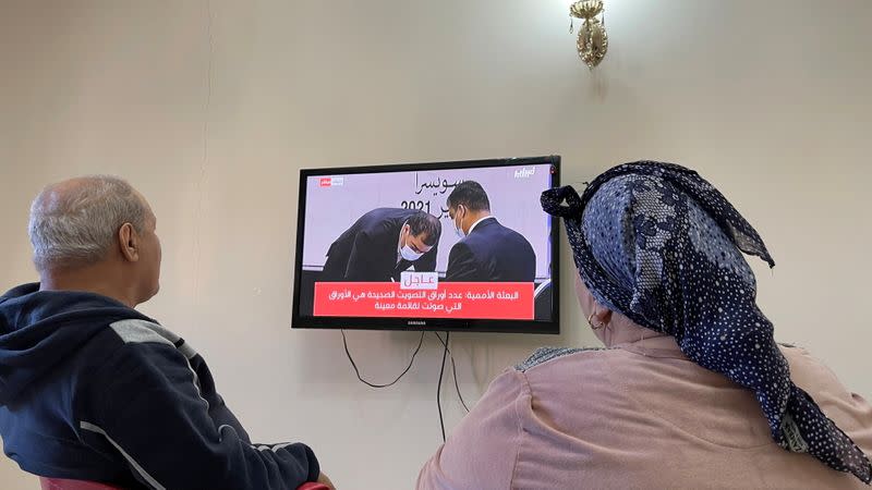 Libyan family watch the elections on a TV screen at home in Tajoura suburb of Tripoli