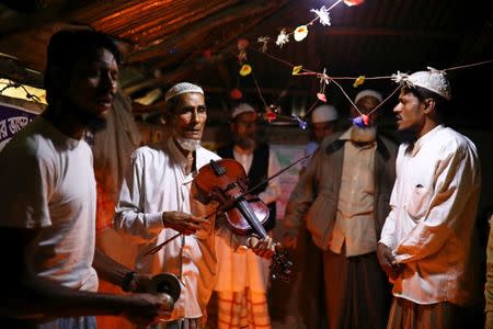 Amir Ali, a Rohingya violinist who was a member of a wedding band of the northern Rakhine State of Myanmar, plays the violin during a weekly prayer event at the Kutupalong refugee camp in Cox's Bazar, Bangladesh, March 7, 2019. REUTERS/Mohammad Ponir Hossain