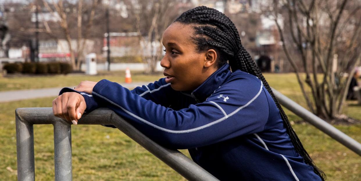 a runner leaning against a metal railing