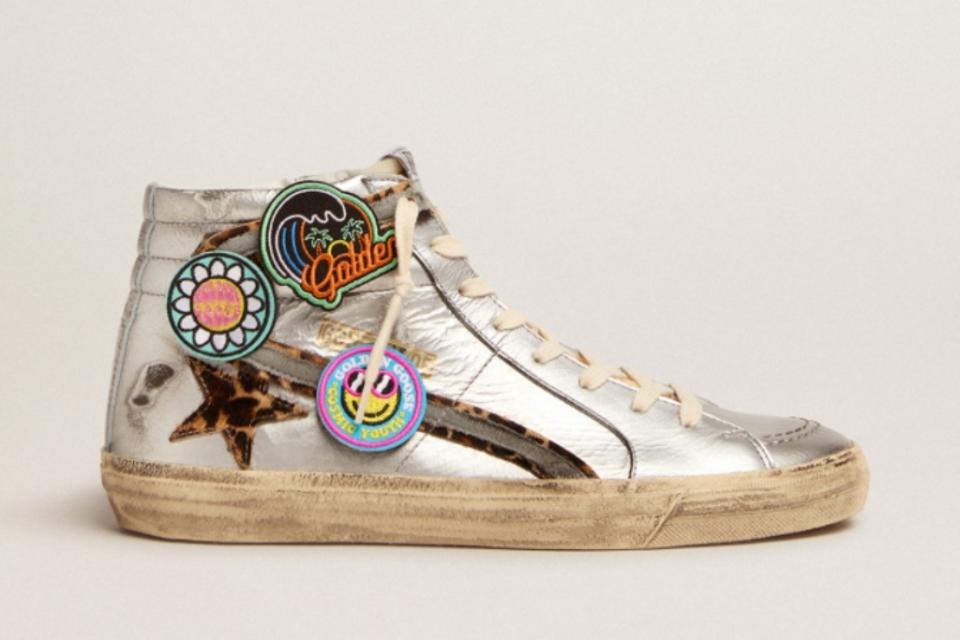 Slide sneakers in silver laminated leather with leopard-print pony skin star and flash with detachable multicolored patches. - Credit: Courtesy of Golden Goose