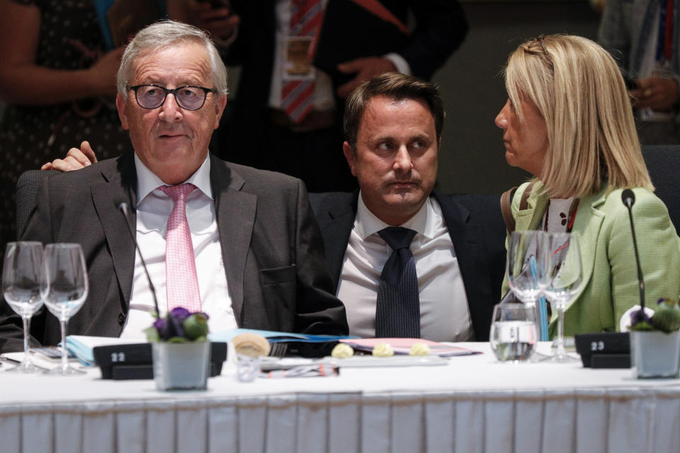 Luxembourg's Prime Minister Xavier Bettel, center, speaks with European Commission President Jean-Claude Juncker, left, during a round table meeting at an EU summit in Brussels, Sunday, June 30, 2019. European Union leaders have started another marathon session of talks desperately seeking a breakthrough in a diplomatic fight over who should be picked for a half dozen of jobs at the top of EU institutions. (Geoffroy Van Der Hasselt, Pool Photo via AP)
