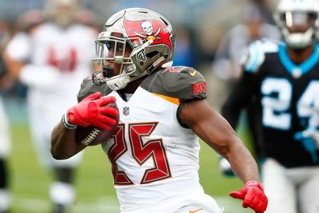 FILE PHOTO: Dec 24, 2017; Charlotte, NC, USA; Tampa Bay Buccaneers running back Peyton Barber (25) runs the ball in the first quarter against the Carolina Panthers at Bank of America Stadium. Mandatory Credit: Jeremy Brevard-USA TODAY Sports