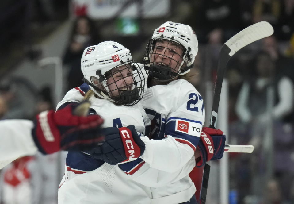 United States defender Caroline Harvey (4) celebrates her goal against Switzerland with teammate Taylor Heise (27) during the first period of a match at the Women's World Hockey Championships in Brampton, Ontario, Friday, April 7, 2023. (Nathan Denette/The Canadian Press via AP)