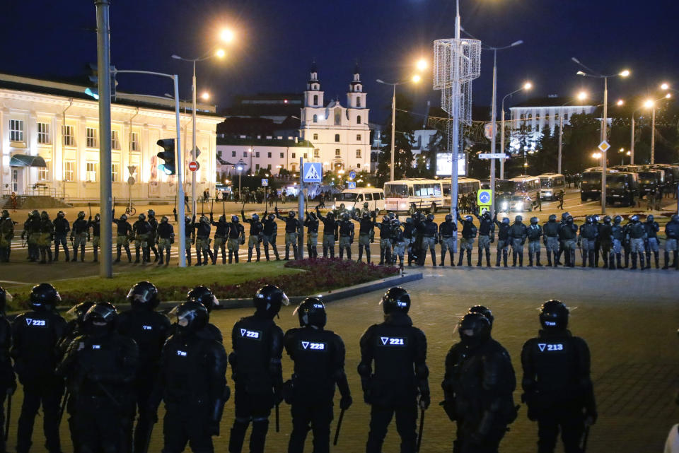 Police block a square during a mass protest following presidential elections in Minsk, Belarus, Monday, Aug. 10, 2020. Thousands of people have protested in Belarus for a second straight night after official results from weekend elections gave an overwhelming victory to authoritarian President Alexander Lukashenko, extending his 26-year rule. A heavy police contingent blocked central squares and avenues, moving quickly to disperse protesters and detained dozens. (AP Photo/Sergei Grits)