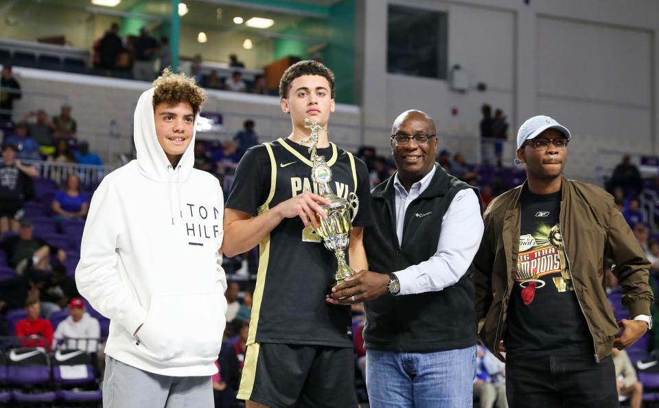 Paul VI player Darren Harris is presented the trophy by Joe North during the 49th annual City of Palms Classic Joe North three-point shootout at Suncoast Arena in Ft. Myers on Sunday, Dec. 18, 2022. 