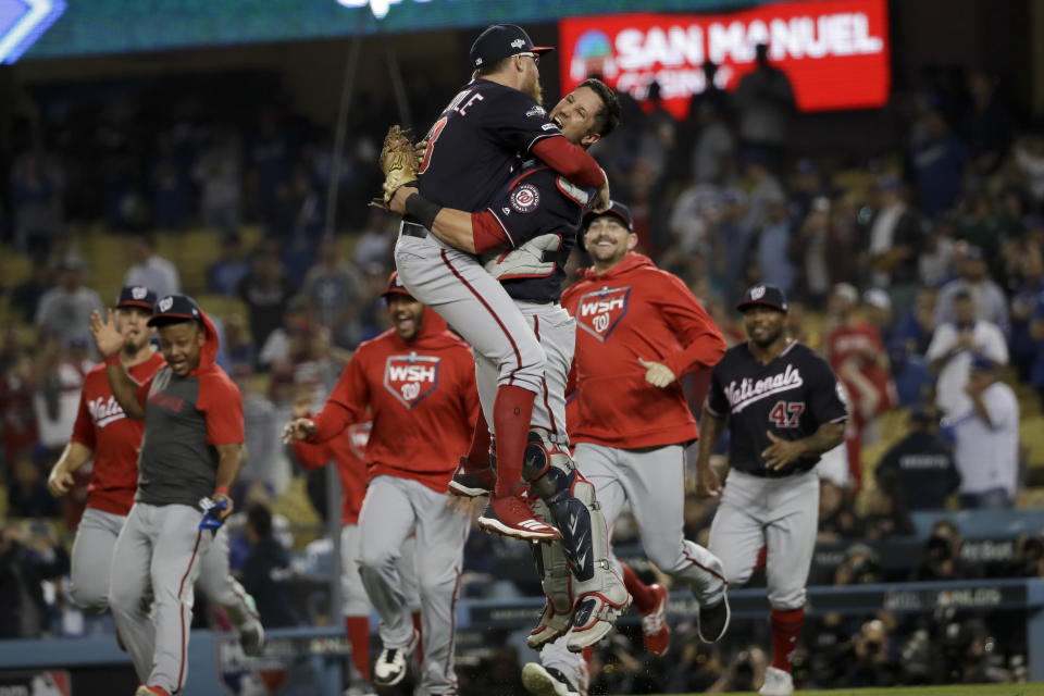 FILE - Washington Nationals pitcher Sean Doolittle, left, and catcher Yan Gomes leap in celebration after the team's 7-3 win in Game 5 of a baseball National League Division Series against the Los Angeles Dodgers, Wednesday, Oct. 9, 2019, in Los Angeles. Sean Doolittle has decided to retire from baseball after more than a decade pitching in the majors that included helping the Washington Nationals win the World Series in 2019. Doolittle announced his decision in a lengthy social media post Friday, Sept. 22, 2023.(AP Photo/Marcio Jose Sanchez)