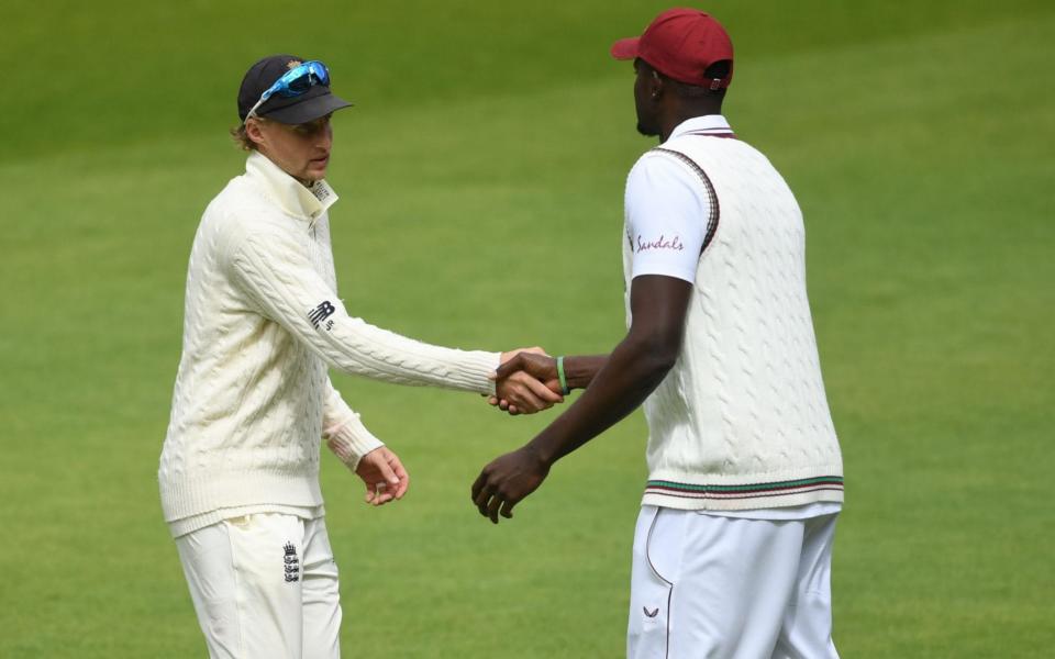 Jason Holder congratulates Joe Root - GETTY IMAGES