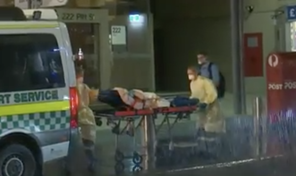 Ambulance officers shown in protective wear rolling a child into an ambulance. Source: Nine/The Today Show