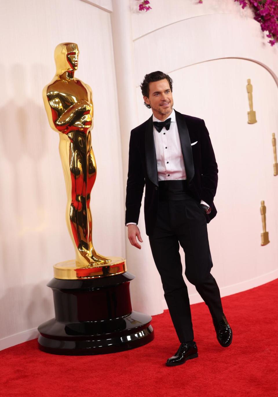 Matt Bomer wears a deep purple tux.