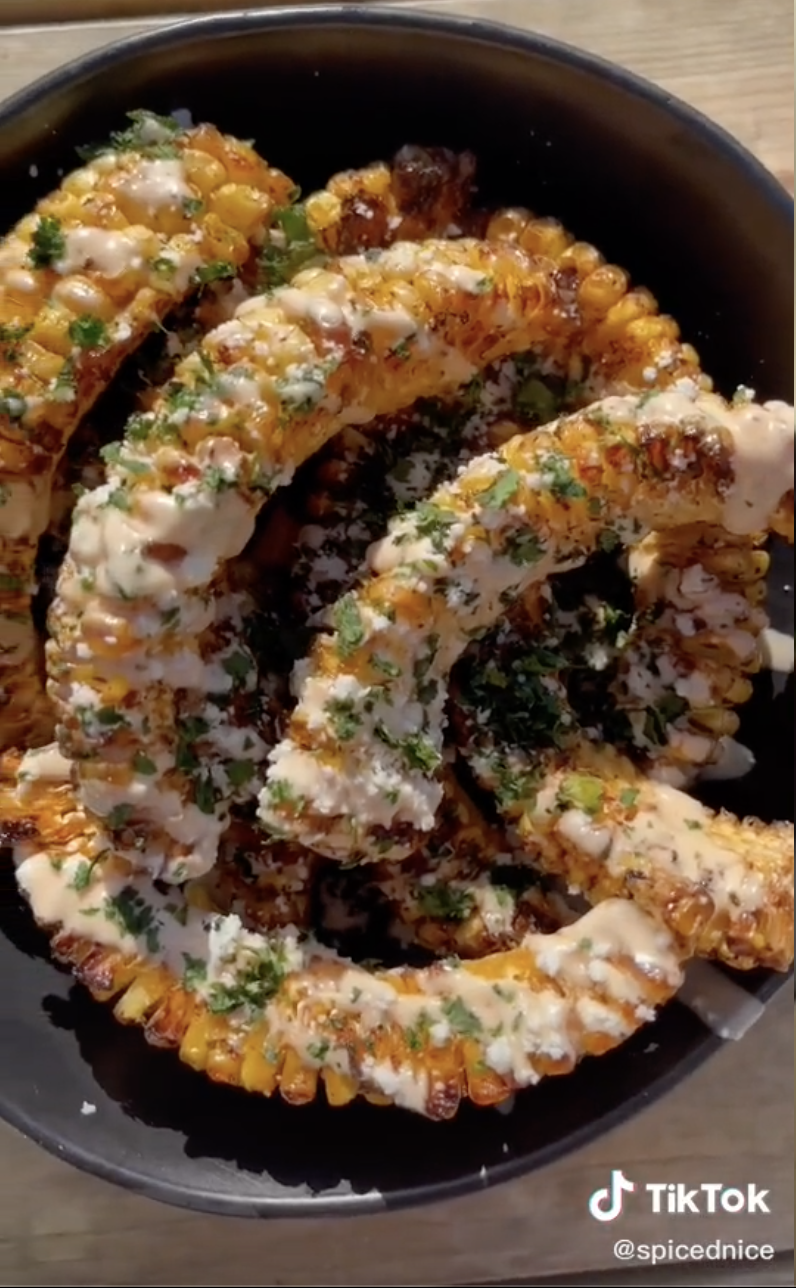 A plate of corn "ribs" topped with cotija cheese and cilantro