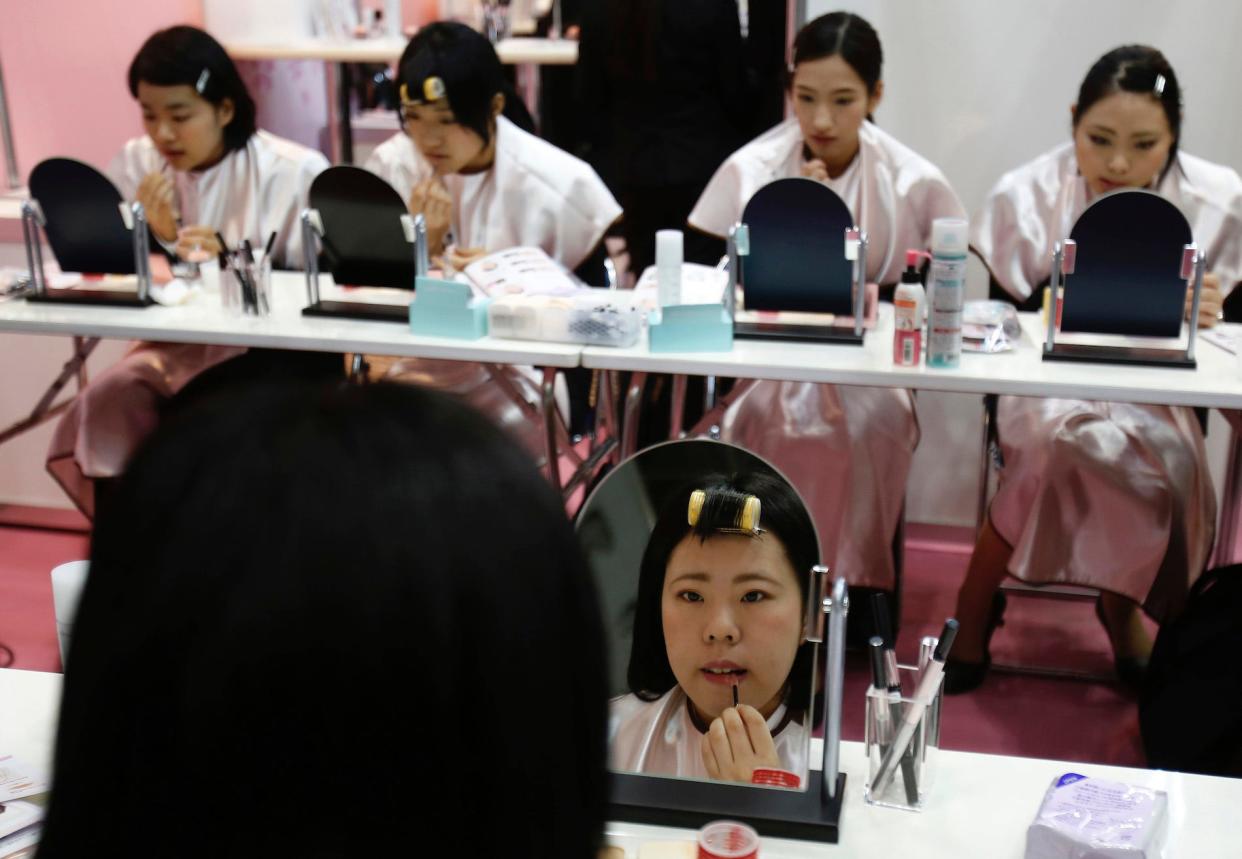 Japanese women applying makeup