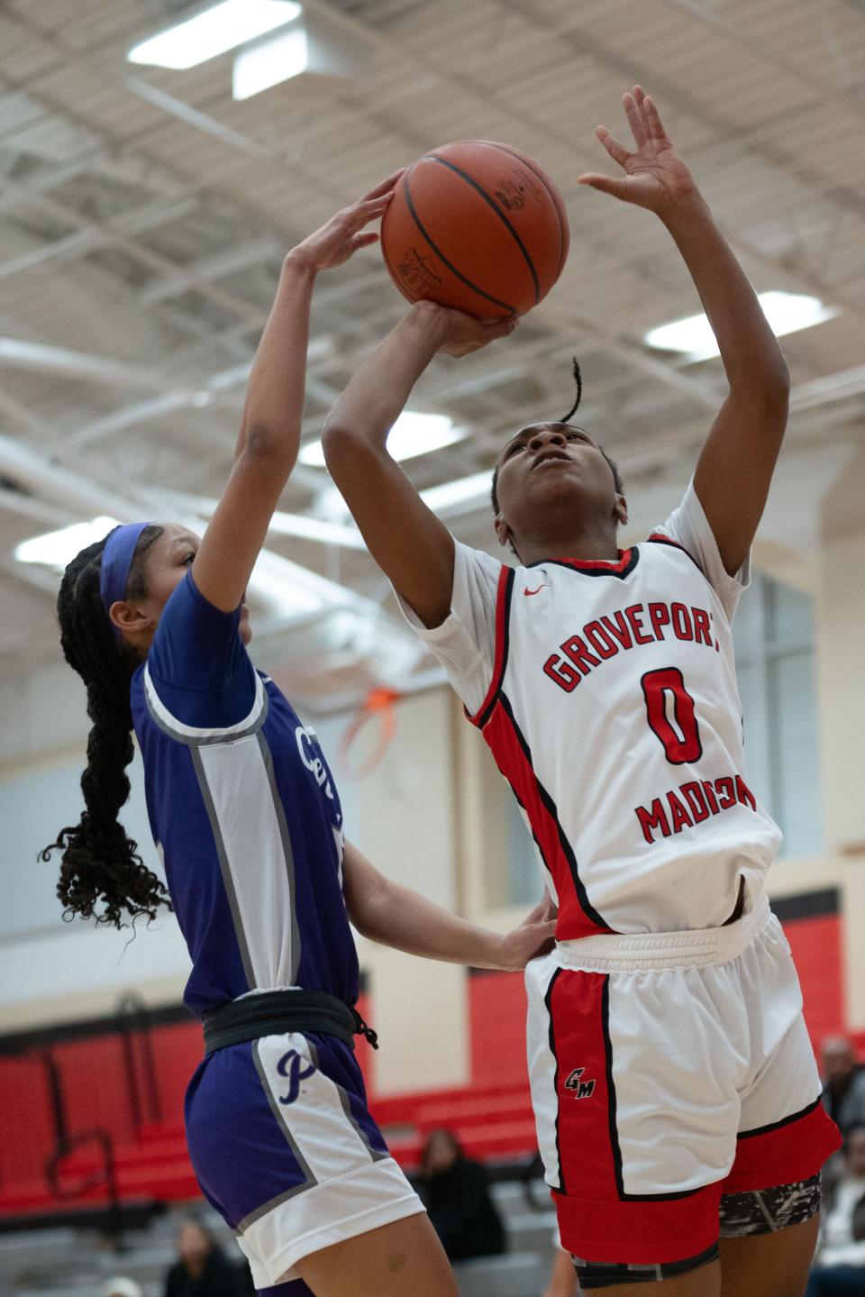 Pickerington Central's Rylee Bess contests a layup attempt by Groveport's Aubriona Benjamin on Friday.