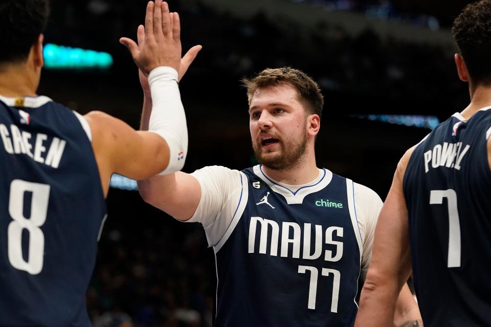 Dallas Mavericks guard Luka Doncic (77) and teammate Josh Green (8) celebrate during the second half of an NBA basketball game against the Miami Heat in Dallas, Friday, Jan. 20, 2023. AP Photo/LM Otero)