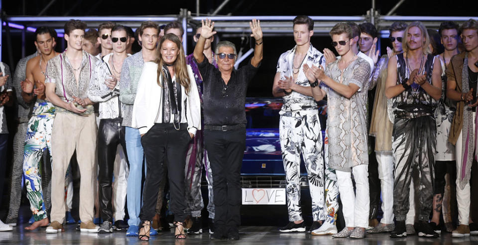 FILE – Italian fashion designer Roberto Cavalli, center, acknowledges the applause of the audience after presenting the Roberto Cavalli men’s Spring-Summer 2015 collection, part of the Milan Fashion Week, in Milan, Italy, June 24, 2014. Italy’s world-famous fashion designer Roberto Cavalli – known for his flamboyant and glamorous style — died on Friday, April 12, 2024 aged 83, his company announced in an Instagram post. (AP Photo/Luca Bruno, File)