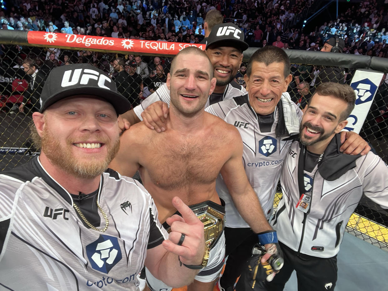 Xtreme Couture coach Eric Nicksick (L) celebrates with Sean Strickland and the rest of the coaching staff after Strickland defeated Israel Adesanya on Saturday. (Courtesy Eric Nicksick)