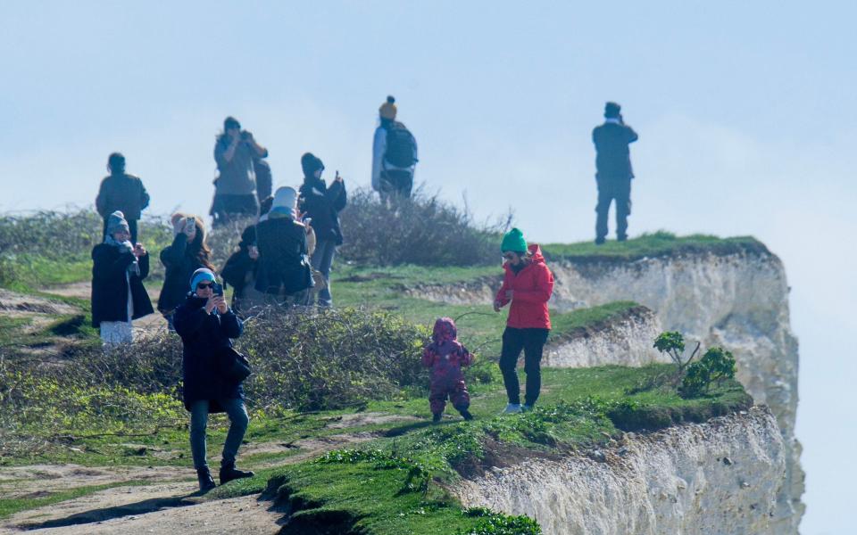 Despite several recent cliff falls, tourists are still risking their lives on the crumbly face of the Birling Gap in East Sussex