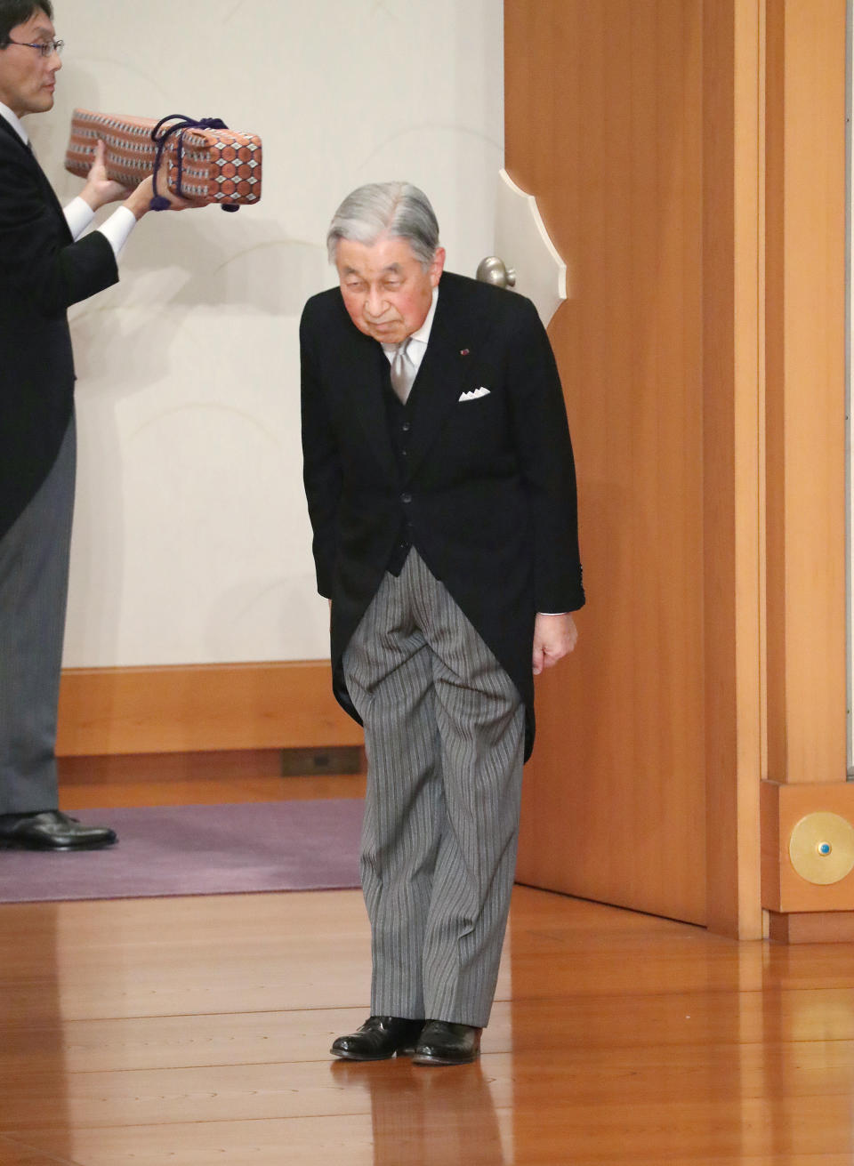 Japan's Emperor Akihito bows before leaving after the ceremony of his abdication in front of other members of the royal families and top government officials at the Imperial Palace in Tokyo, Tuesday, April 30, 2019. The 85-year-old Akihito ends his three-decade reign on Tuesday as his son Crown Prince Naruhito will ascend the Chrysanthemum throne on Wednesday. (Japan Pool via AP)