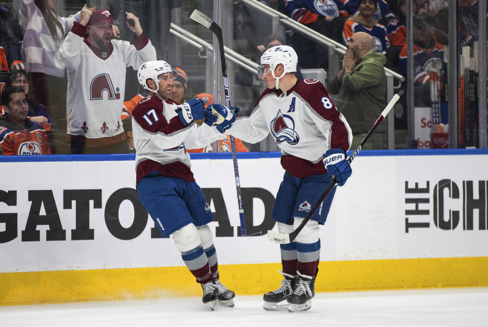 Colorado Avalanche's Brad Hunt (17) and Cale Makar (8) celebrate a goal against the Edmonton Oilers during the third period of an NHL hockey game Saturday, Jan. 7, 2023, in Edmonton, Alberta. (Jason Franson/The Canadian Press via AP)