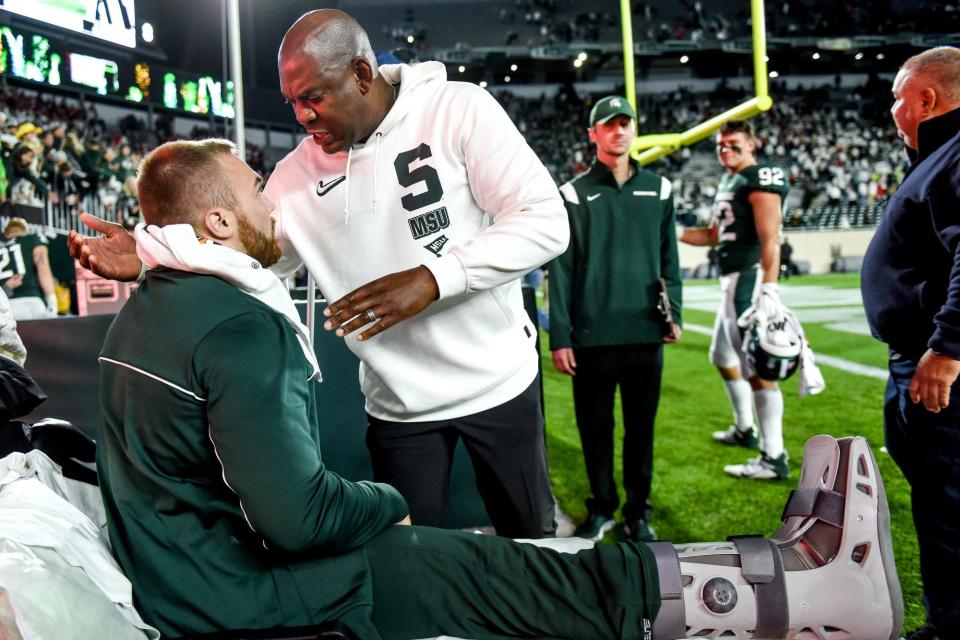 Michigan State head coach Mel Tucker, right, hugs Drew Beesley after beating Nebraska in overtime on Saturday, Sept. 25, 2021, at Spartan Stadium in East Lansing. Beesley injured his right leg in the first half.