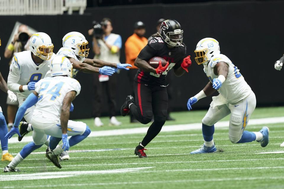 Chargers defensive tackle Sebastian Joseph-Day, right, pursues Falcons running back Cordarrelle Patterson (84).