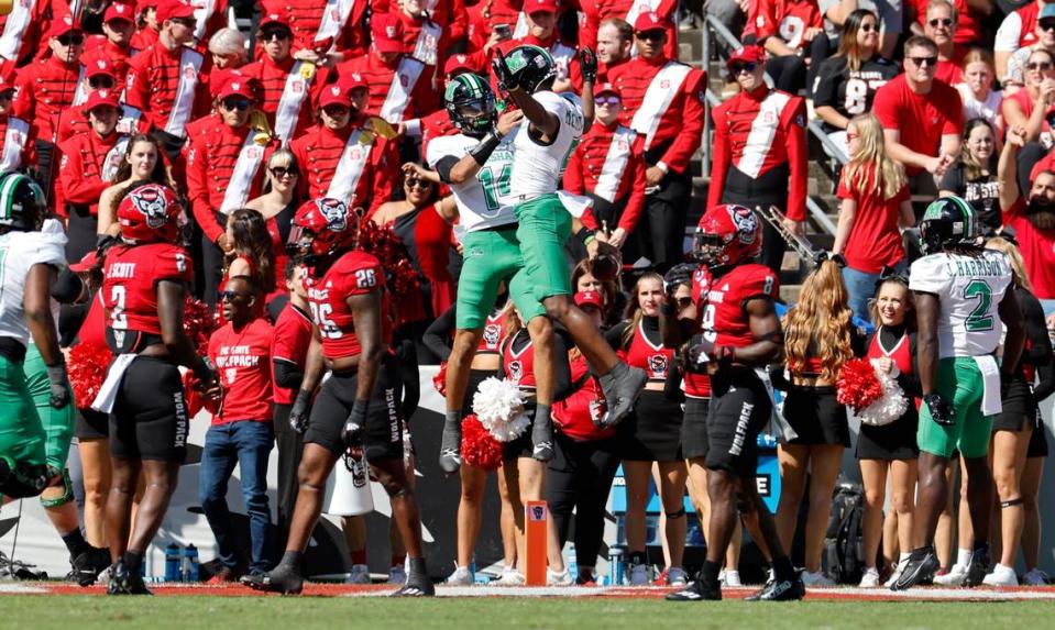 Marshall quarterback Cam Fancher (14) celebrates with Caleb McMillan (5) after Fancher scored on a 7-yard touchdown run during the first half of N.C. State’s game against Marshall at Carter-Finley Stadium in Raleigh, N.C., Saturday, Oct. 7, 2023.