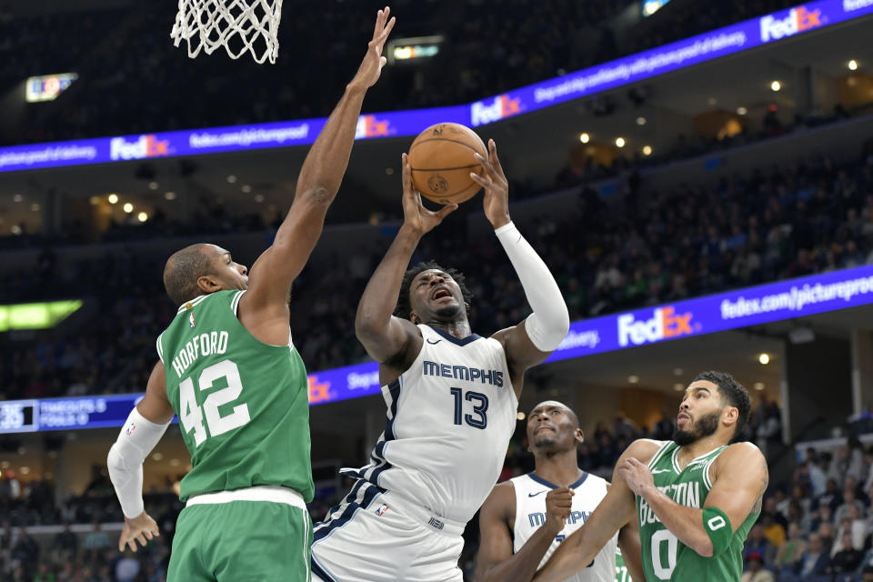 Memphis Grizzlies forward Jaren Jackson Jr. (13) shoots against Boston Celtics center Al Horford (42) in the first half of an NBA basketball game Sunday, Nov. 19, 2023, in Memphis, Tenn. (AP Photo/Brandon Dill)