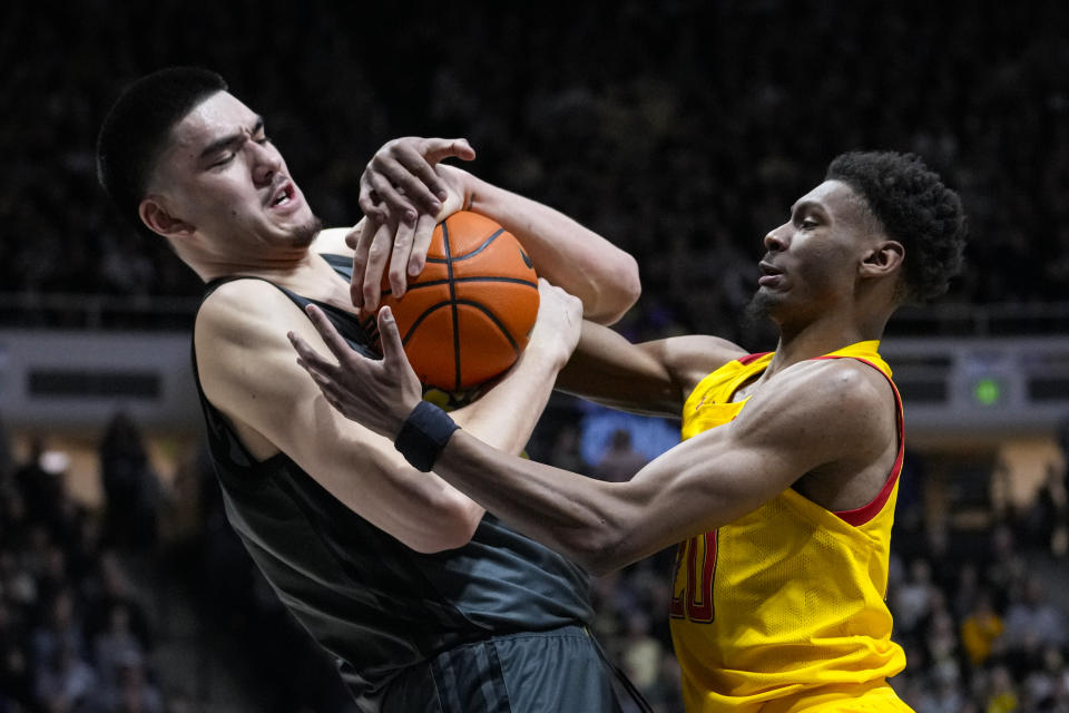 Purdue center Zach Edey (15) and Maryland forward Ike Cornish (20) fight for a rebound during the first half of an NCAA college basketball game in West Lafayette, Ind., Sunday, Jan. 22, 2023. (AP Photo/Michael Conroy)