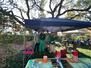 Dawson Victor, Harry Putt, Ted Sticles and Harrison Mills staked out a spot in Wright Square for their tent to watch the parade.